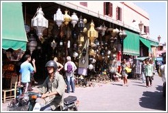 Man on a scooter in front of a lamp shop, Place Bab Fteuh.