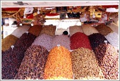 Boy asleep, manning a dried fruit stand in the midday heat, Jemaa el Fna.