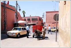 Taxi and man with a donket in the Medina.