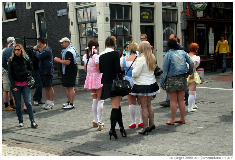 Women dressed in schoolgirl clothes, corner of Prins Hendrikkade and Nieuwendijk, Centrum district.