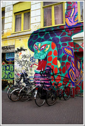 Snake painting on building, with bikes in front.  Spuistraat, Centrum district.