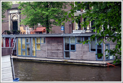 Houseboat with furniture on top, Prinsengracht canal, Jordaan district.