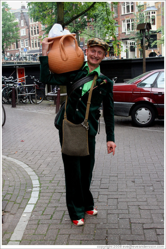 Man holding planter.  Jordaan district.