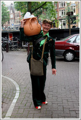 Man holding planter.  Jordaan district.