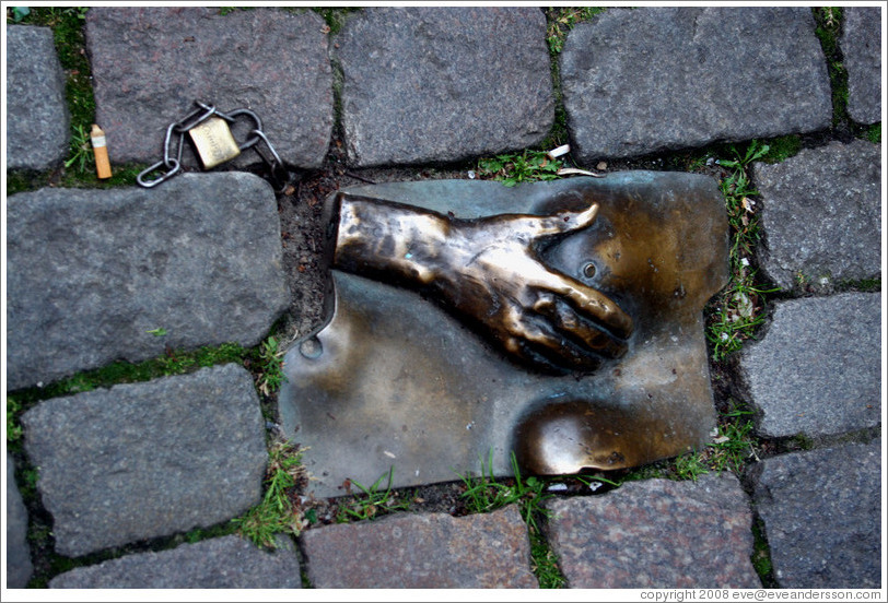 Sculpture of hand and breasts embedded in sidewalk.  Red Light district.