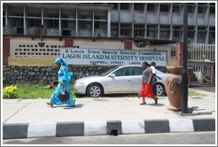 Women walking past the Campbell Street Lagos Island Maternity Hospital.