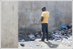 Man urinating. Lagos Island.