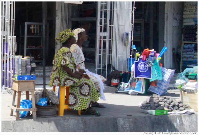 Two women and a pile of rocks. Lagos Island.