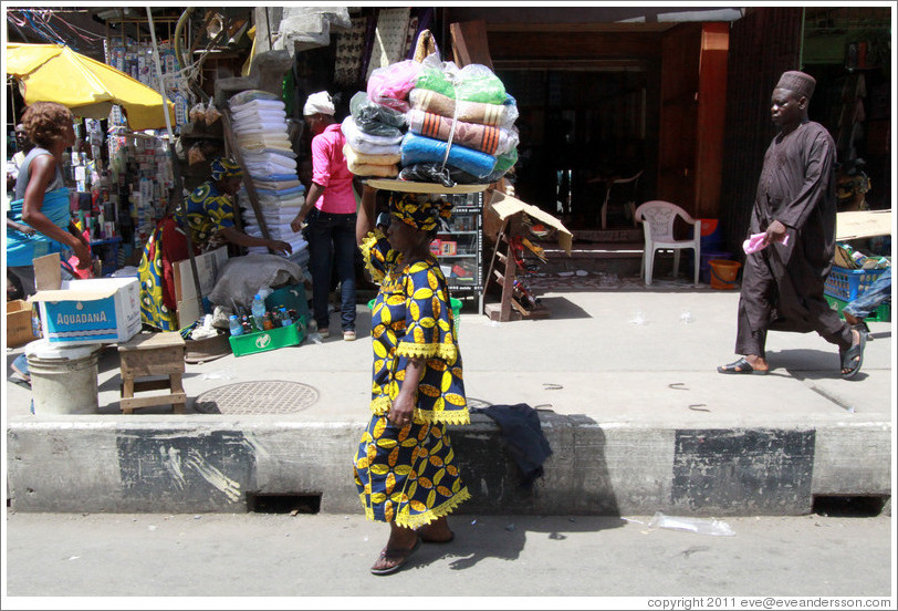 Woman with a bundle of cloths on her head.
