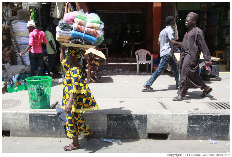 Woman with a bundle of cloths on her head.