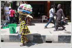 Woman with a bundle of cloths on her head.