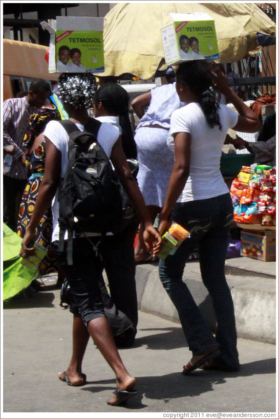 Two women with Tetmosol boxes.