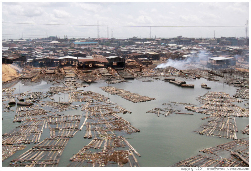 Timber being dried with fire. Makoko, a slum on the Lagos Lagoon.