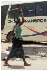 Woman carrying baskets. Lekki-Epe Expressway, Victoria Island.