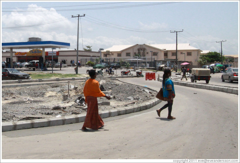 Two women walking. Lekki-Epe Expressway, Victoria Island.