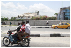 Three men on a motorcycle. Maroko Road, Victoria Island.