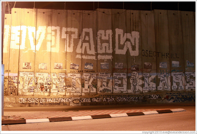 Graffiti on a wall at night.