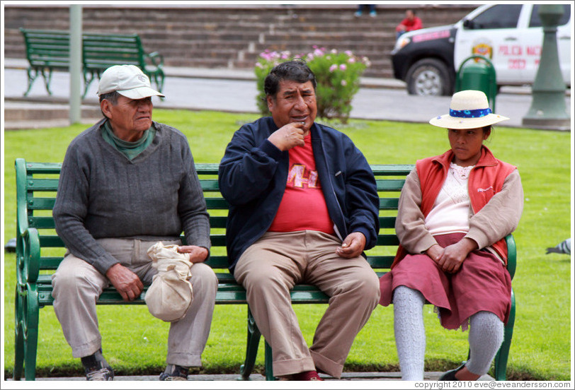 Two men and a woman on a bench, Plaza de Armas.