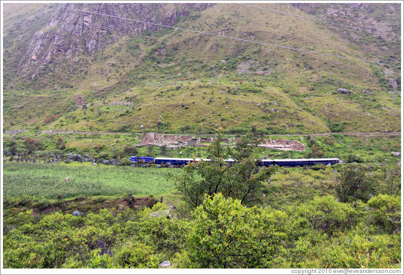 Inca ruins with a train passing by, seen from the Inca Trail.