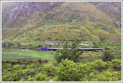 Inca ruins with a train passing by, seen from the Inca Trail.