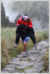 Sick woman carried by a porter on the Inca Trail.