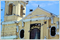 Pigeons flying in front of Iglesia de San Francisco, Historic Center of Lima.