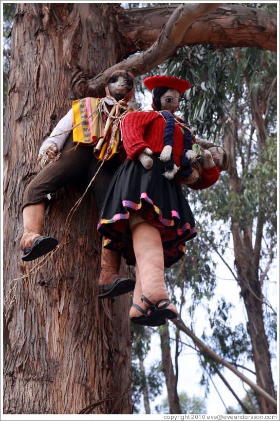 Almost life-sized dolls hanging from a tree, Qenko ruins.