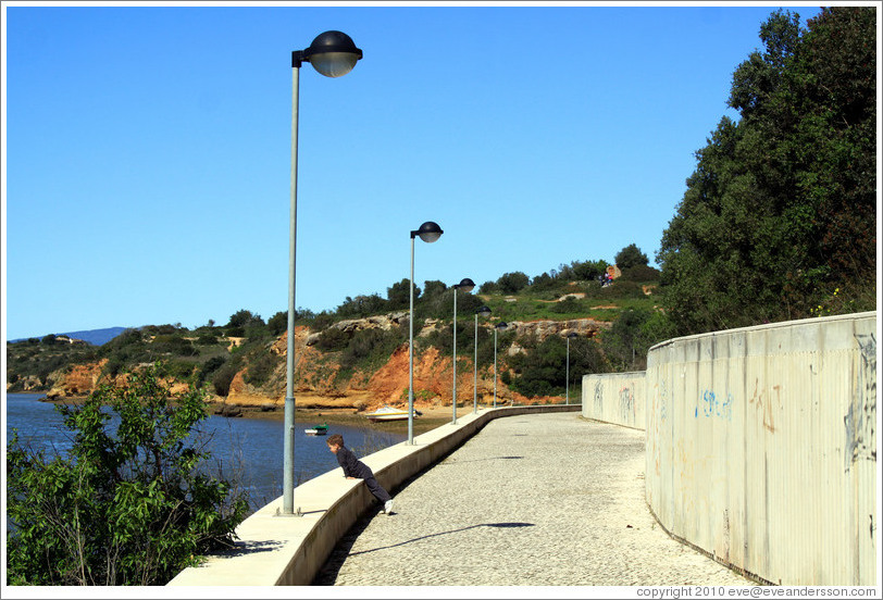 Child looking out to the sea, coastal path, Alvor.