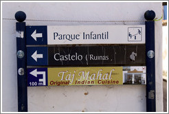 Sign reading Parque Infantil (playground), Castelo Ruinas (castle ruins), and Taj Mahal Original Indian Cuisine.