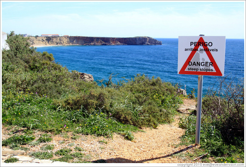 Sign reading "Perigo arribas inst?is", which loosely translates as "Come this way for a great photo op."  Fortaleza de Sagres (Sagres Fortress).