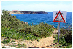Sign reading "Perigo arribas inst?is", which loosely translates as "Come this way for a great photo op."  Fortaleza de Sagres (Sagres Fortress).