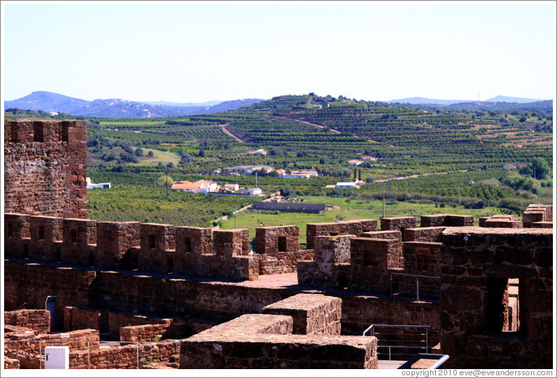 Silves Castle, with green fields behind it.
