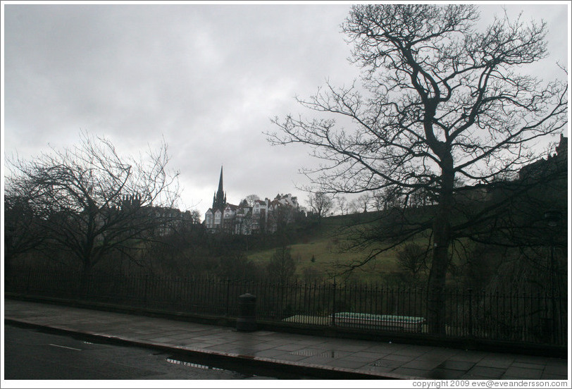 Princes Street Gardens on an overcast day.  In the background are buildings designed by Sir Patrick Geddes in 1893.