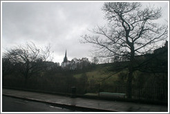 Princes Street Gardens on an overcast day.  In the background are buildings designed by Sir Patrick Geddes in 1893.