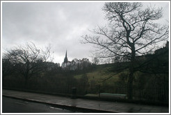 Princes Street Gardens on an overcast day.  In the background are buildings designed by Sir Patrick Geddes in 1893.