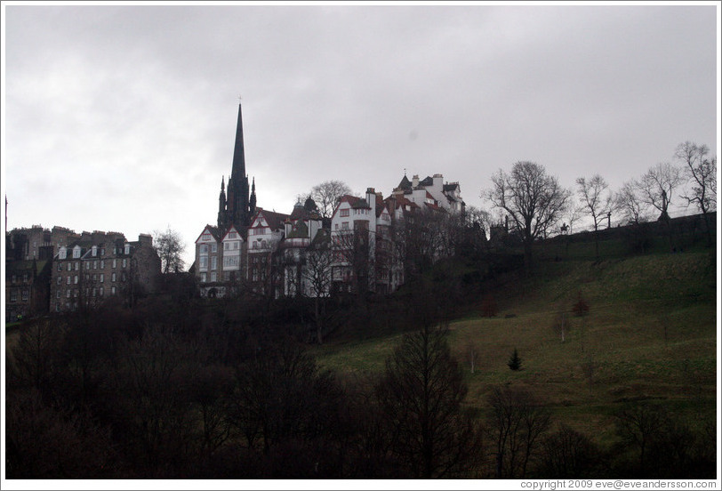 Princes Street Gardens on an overcast day.  In the background are buildings designed by Sir Patrick Geddes in 1893.