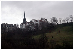 Princes Street Gardens on an overcast day.  In the background are buildings designed by Sir Patrick Geddes in 1893.