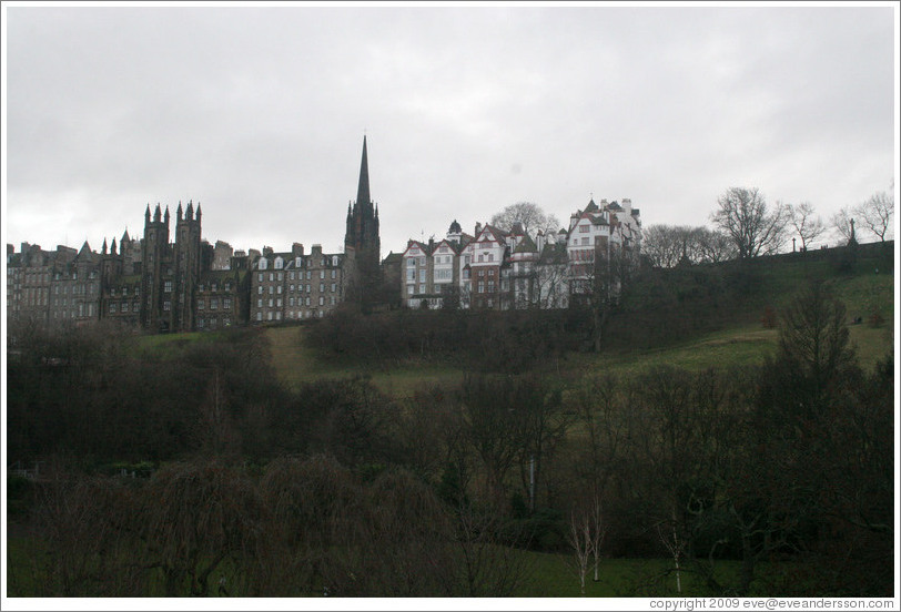 Princes Street Gardens on an overcast day.  In the background are buildings designed by Sir Patrick Geddes in 1893 and other Old Town buildings.