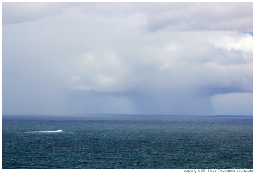 Rain storm. The rough patch of water at the left is caused by an underwater mountain.