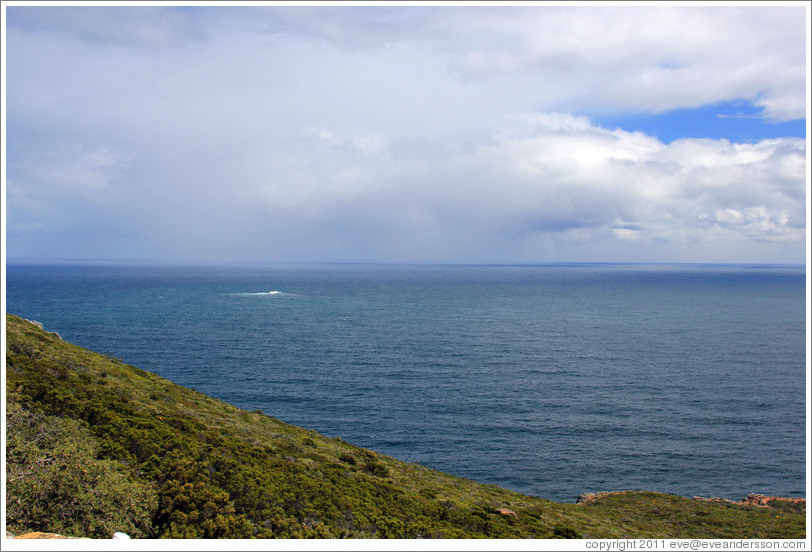 The rough patch of the water at the left is caused by an underwater mountain.