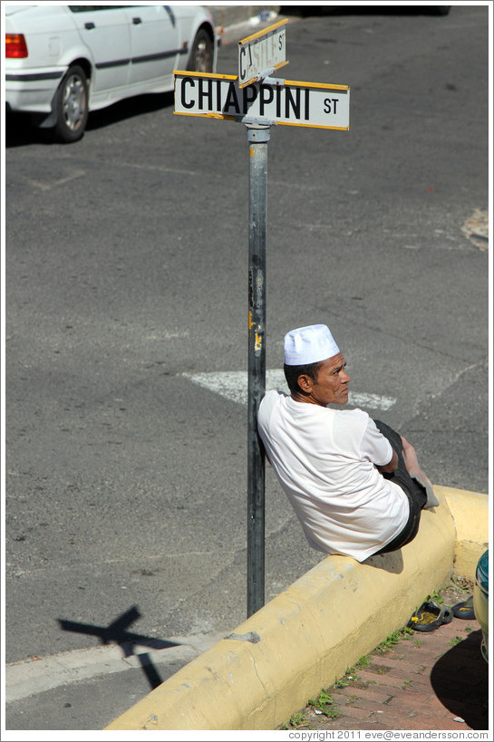Man resting against street sign, Bo-Kaap.