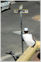 Man resting against street sign, Bo-Kaap.