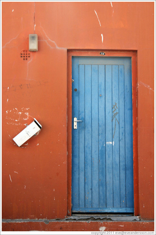 Orange building with blue door. Chiappini Street, Bo-Kaap.