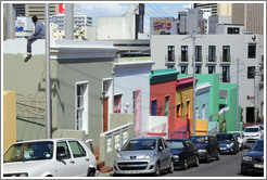 Hout street, Bo-Kaap.  A man is sitting on the roof at the left.