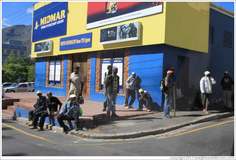 People standing at the corner, looking for work.  Rose Street and Strand Street, Bo-Kaap.