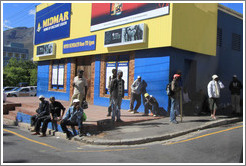 People standing at the corner, looking for work.  Rose Street and Strand Street, Bo-Kaap.