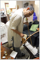 Cape Town jazz musician Hilton Schilder playing a bow in his home.