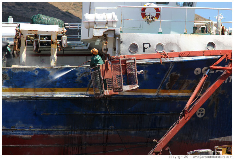 Man cleaning a boat.