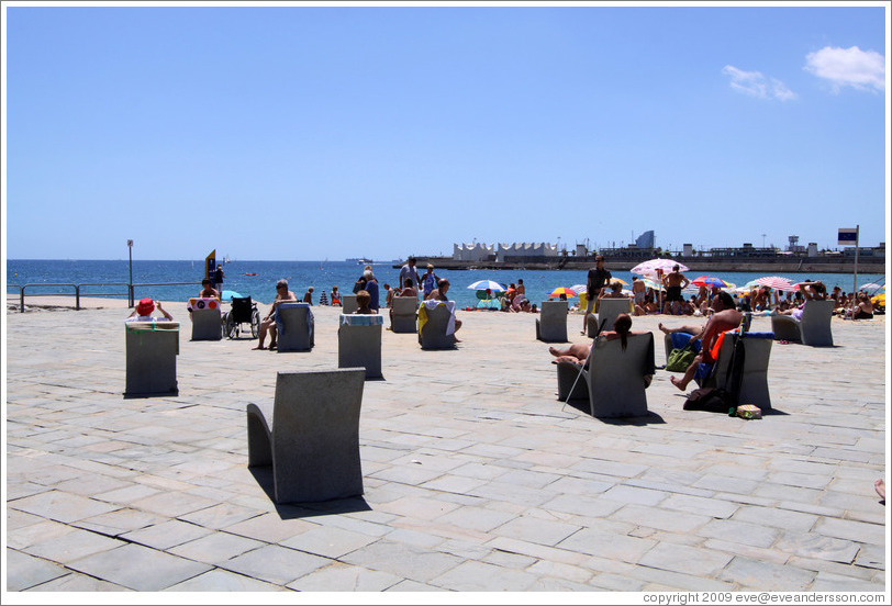 Stone beach chairs between Bogatell beach and Nova Ic?a beach.