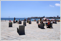 Stone beach chairs between Bogatell beach and Nova Ic?a beach.